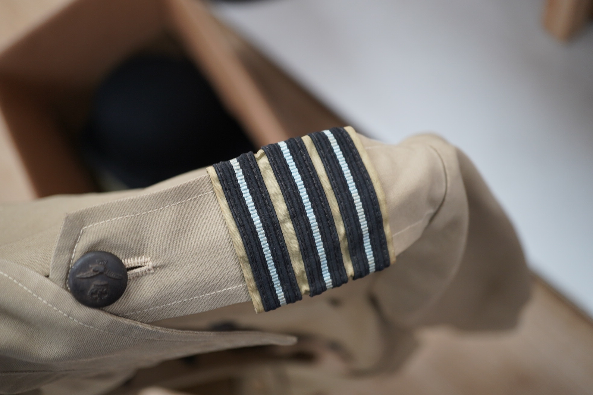 Two post-WWII RAF uniforms, one with applied medal ribbons, an RAF cap, and related buttons, together with a bowler hat and two Arab daggers. Condition - good